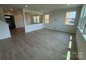 Bright open-concept living area featuring wood floors and large windows overlooking the yard at 346 Knotty Wood Dr # 71, Monroe, NC 28110