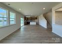 Bright and spacious living room with abundant natural light, sleek flooring, an open floor plan, and a kitchen view at 346 Knotty Wood Dr # 71, Monroe, NC 28110