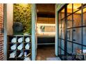 Modern bathroom with mossy wall art, open towel storage and a vanity with a mirrored wall at 4313 Kingswood Rd, Charlotte, NC 28226