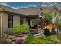 Charming side exterior featuring an outdoor seating area and beautiful landscaping at 4313 Kingswood Rd, Charlotte, NC 28226