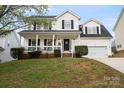 Charming two-story home with a welcoming front porch and well-maintained landscaping at 6019 Timbertop Ln, Charlotte, NC 28215