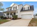 Traditional two-story home with a covered porch and attached two-car garage at 6019 Timbertop Ln, Charlotte, NC 28215