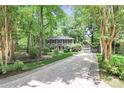 Beautiful home with an attached garage, lush landscaping, and a tree-lined driveway at 11 Tanglewood Rd, Lake Wylie, SC 29710