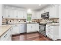 Bright kitchen featuring white cabinets, stainless steel appliances, and granite countertops at 11 Tanglewood Rd, Lake Wylie, SC 29710