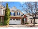 Well-maintained home featuring brick accents, a two-car garage, and manicured landscaping at 12124 Red Rust Ln, Charlotte, NC 28277