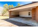 Spacious carport offers shelter and convenience with brick detail and utility door at 126 Regal Cir # 2122, Mooresville, NC 28115