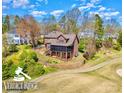 Charming brick home with a screened porch, situated on a beautifully landscaped lot with golf course views at 1316 Valhalla Dr, Denver, NC 28037