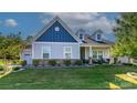 Charming single-Gathering home featuring a craftsman style, well-manicured lawn, and inviting curb appeal at 1512 Brooksland Pl, Waxhaw, NC 28173