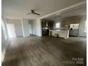 A combined living room and kitchen with dark wood floors, recessed lights, and an eat-in island at 2070 Travis Rd, Conover, NC 28613