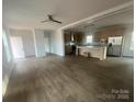 Open-concept living room with wood floors seamlessly connects to the modern kitchen with stainless steel appliances at 2070 Travis Rd, Conover, NC 28613