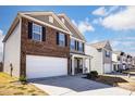 Exterior showcases a row of two-story homes, each with a two-car garage and well-kept yards at 2135 Eastway Dr, Dallas, NC 28034