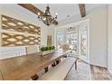 Bright dining room featuring wood beams, a decorative chandelier, and an elegant bay window at 2604 Lamplighter Dr, Kannapolis, NC 28081