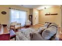 Cozy living room with hardwood floors, natural light, and comfortable seating at 3426 Dominion Green Dr, Charlotte, NC 28269