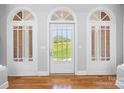 Bright foyer with hardwood floors and a scenic view through the front door at 447 Willow Pond Ln, Hiddenite, NC 28636