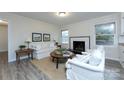Inviting living room with comfortable furniture and a fireplace at 4601 Mendham Dr, Charlotte, NC 28215