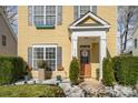 Inviting front porch with decorative features, including lush greenery and white rock landscaping at 4741 Eaves Ln, Charlotte, NC 28215