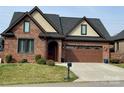 Inviting brick home with a two-car garage, manicured lawn, and classic architectural details at 6111 Gold Springs Way, Denver, NC 28037