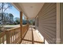 View of the spacious, covered porch showing the wood flooring, rail and siding at 647 Black E St, Rock Hill, SC 29730