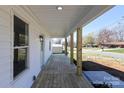 Covered front porch with wood decking, and wooden support columns, offering a relaxing outdoor space at 1018 Union St, Maiden, NC 28650