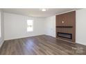 Living room showcases a modern fireplace feature wall and wood-look laminate flooring at 1018 Union St, Maiden, NC 28650