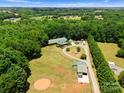 Sprawling estate with mature trees, circular driveway, horse paddock, and outbuildings at 1363 John Cline Ct, Lincolnton, NC 28092