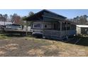 Exterior view of charming property with awning, porch, and gravel driveway with a boat on the side at 143 Sunshine Trl # A32, Mount Gilead, NC 27306