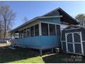 Home featuring an awning, porch, screened in area and a storage shed at 143 Sunshine Trl # A32, Mount Gilead, NC 27306