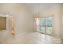 Bright dining area featuring tiled floor, chandelier and large windows at 1730 Sanridge Wind Ln, Charlotte, NC 28262