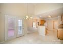 Open dining area with tiled floor, chandelier and access to brick patio at 1730 Sanridge Wind Ln, Charlotte, NC 28262