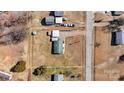 Aerial view of property showcasing layout with house, sheds, large yard, and proximity to the road at 1802 Young Dr, Conover, NC 28613