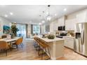 Open concept kitchen with stainless steel appliances, a large island, and seamless flow to dining and living area at 212 Laura Elizabeth Ln, Clover, SC 29710