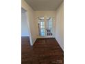 Hallway featuring beautiful hardwood floors and French doors leading to another room at 304 Taft St, Troy, NC 27371