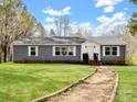 Charming single-story home with gray siding, white trim, and a gravel path leading to the front door at 33 Travora Cir, York, SC 29745