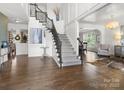 Bright, open foyer with hardwood floors, elegant staircase, and decorative accents at 604 Wisteria Walk Way, Fort Mill, SC 29715