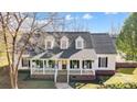 Beautiful two-story home with a classic front porch, dormer windows, and shutters at 737 Sanside Dr, York, SC 29745