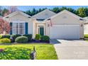 Charming single-story home with a well-manicured lawn, attached garage, and inviting front entrance at 974 Platinum Dr, Fort Mill, SC 29708