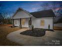 Charming exterior of a home showcasing stone columns and a well-manicured lawn at 1313 Gidney St, Shelby, NC 28150
