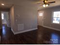 Bright living room showcasing hardwood floors, fresh paint, and natural light at 211 W Roswell St, Troy, NC 27371