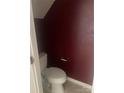 A cozy half bathroom featuring a toilet and decorative wall paint at 5650 Kimmerly Woods Dr, Charlotte, NC 28215