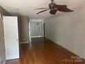 A spacious living room featuring hardwood floors and a ceiling fan at 5650 Kimmerly Woods Dr, Charlotte, NC 28215