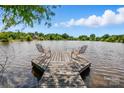 Lake view with dock featuring two chairs under a partly cloudy blue sky at 7204 E 218 Hwy, Marshville, NC 28103