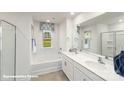 Bright bathroom featuring double sink vanity, soaking tub, and window providing natural light at 7882 Old Brook Rd, Sherrills Ford, NC 28673