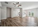 A spacious living room featuring a ceiling fan and seamless connection to the kitchen and dining area at 10036 Brittondale Ln, Charlotte, NC 28215