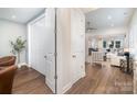 Bright entryway featuring wood floors, coat closet and an open view to the living room at 10421 Superb Ln, Charlotte, NC 28215