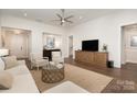 Bright and airy living room featuring hardwood floors, and a ceiling fan at 10421 Superb Ln, Charlotte, NC 28215