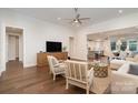 Bright and airy living room featuring hardwood floors, and an open view to the kitchen and dining room at 10421 Superb Ln, Charlotte, NC 28215