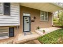 Inviting front entry of the house with a modern door, brick facade, and manicured landscaping at 107 Wedgewood Ne Cir, Concord, NC 28025