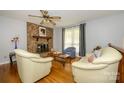 Cozy living room featuring hardwood floors, a brick fireplace, and comfortable seating arrangement at 107 Wedgewood Ne Cir, Concord, NC 28025