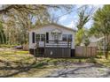 Charming single-story home with a welcoming front porch and a quaint, fenced yard at 115 Belton Ave, Mount Holly, NC 28120