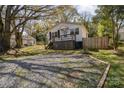 Charming single-story home with a front porch and a gravel driveway at 115 Belton Ave, Mount Holly, NC 28120